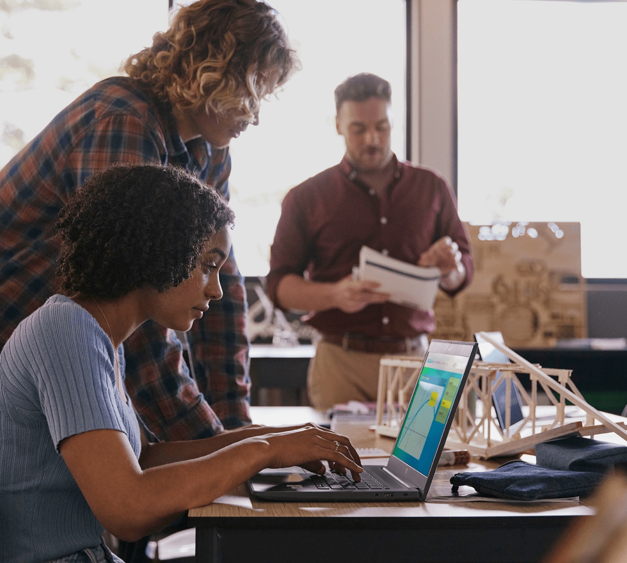 Woman working on laptop computer at school