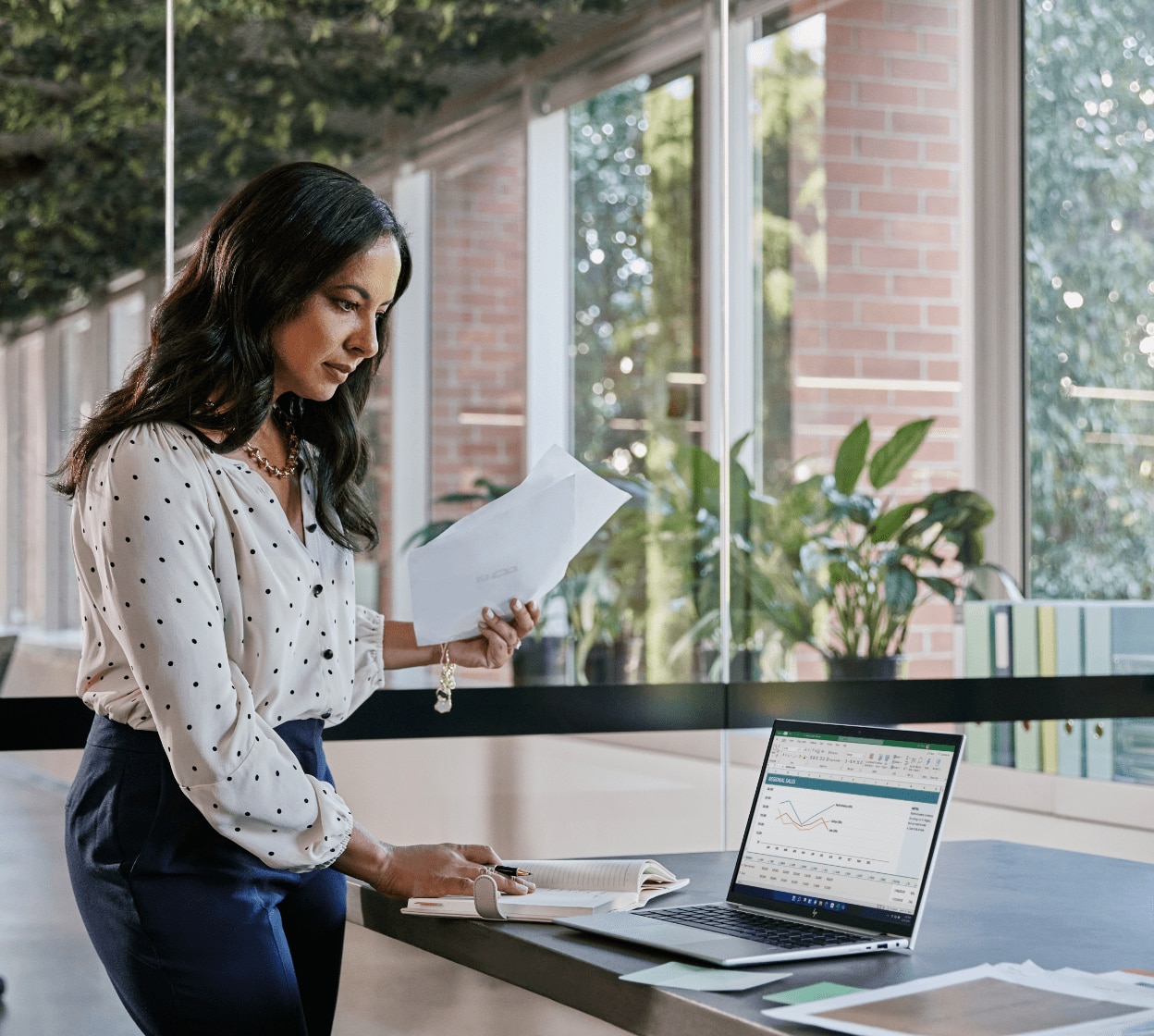 Woman analyzes data on HP laptop