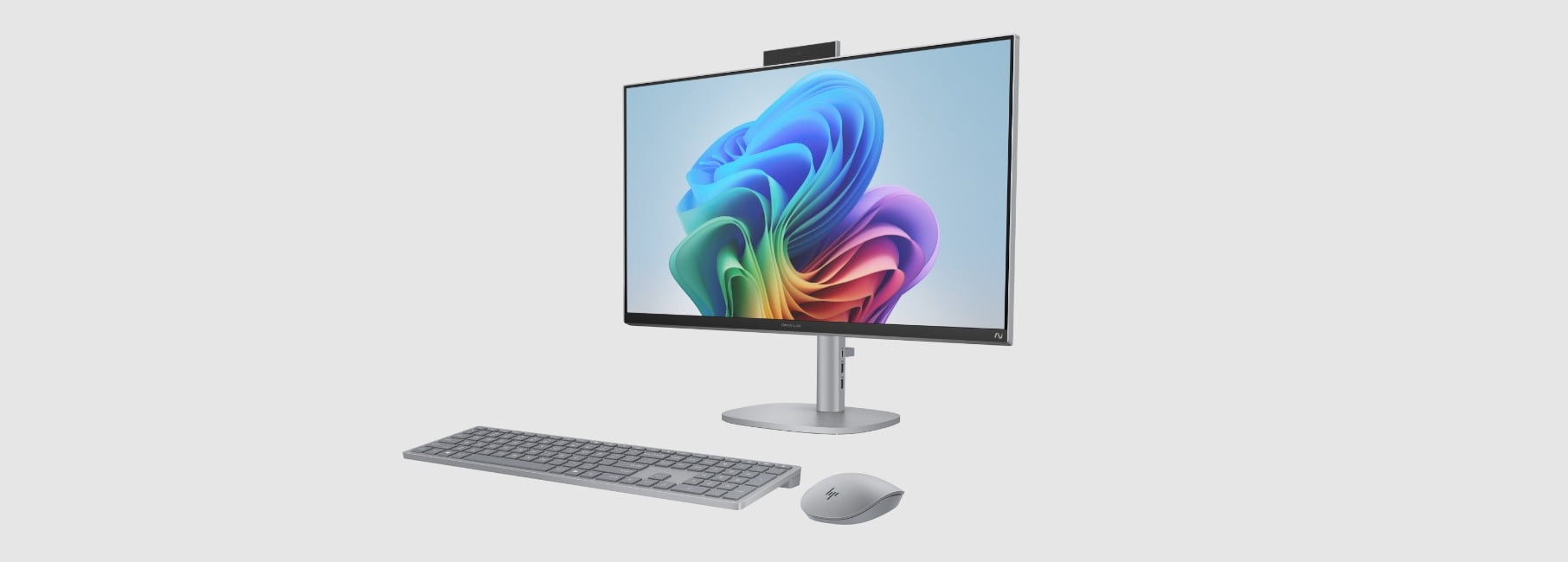 An HP OmniStudio X All-in-One AI PC with blue wireless mouse and keyboard