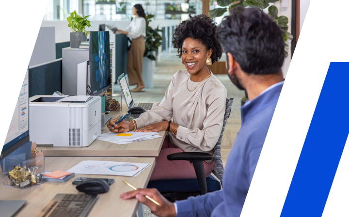 People talking near work station in an office