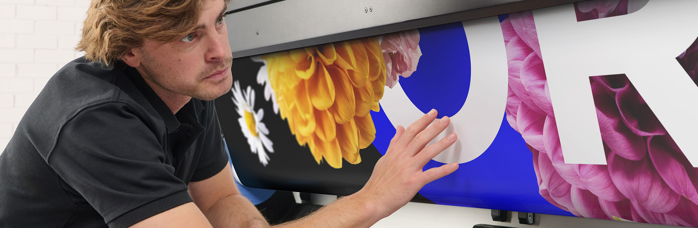 Person checking printed media on an HP Latex printer
