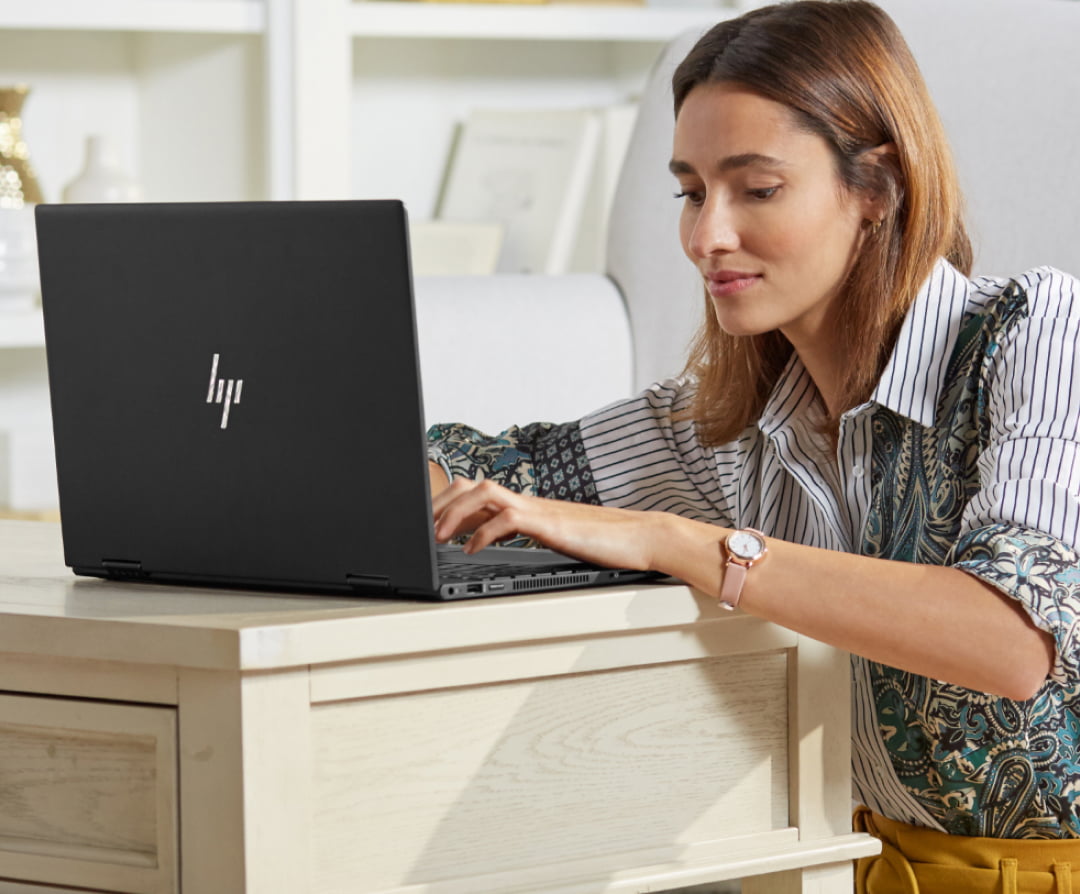 female professional at home using HP laptop for video call with family