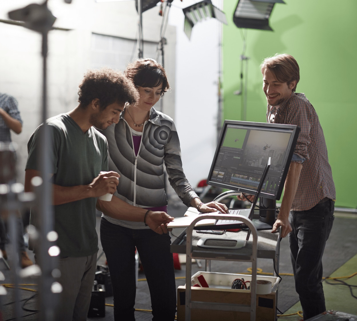 Crew works behind the scenes in studio on laptop