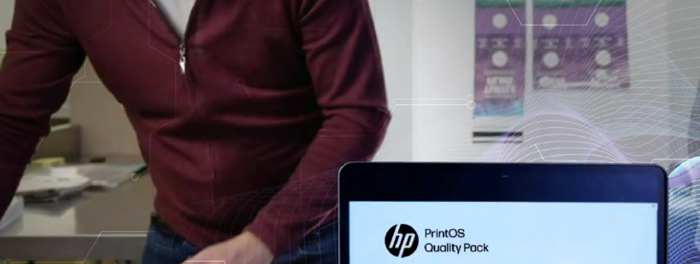 A person standing next to a computer with the PrintOS Quality Pack application