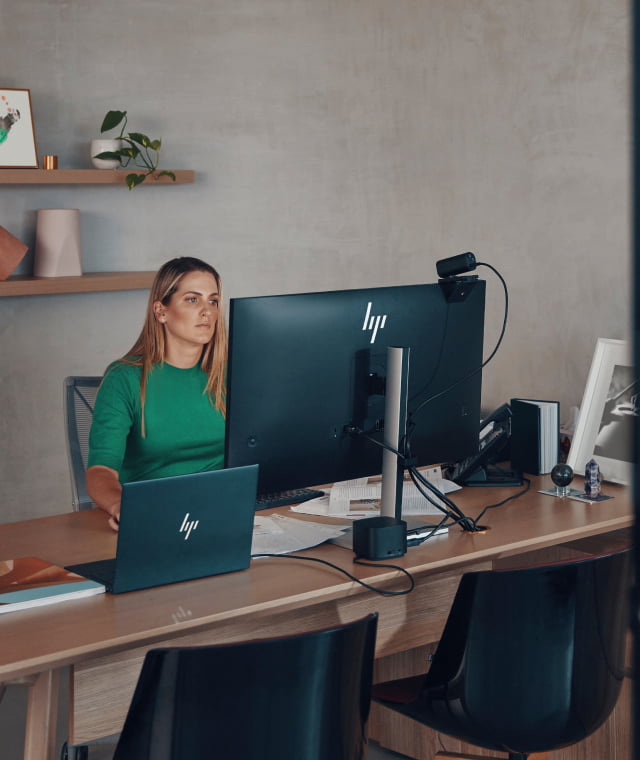Woman using a laptop in a modern office, representing the future of work and digital transformation