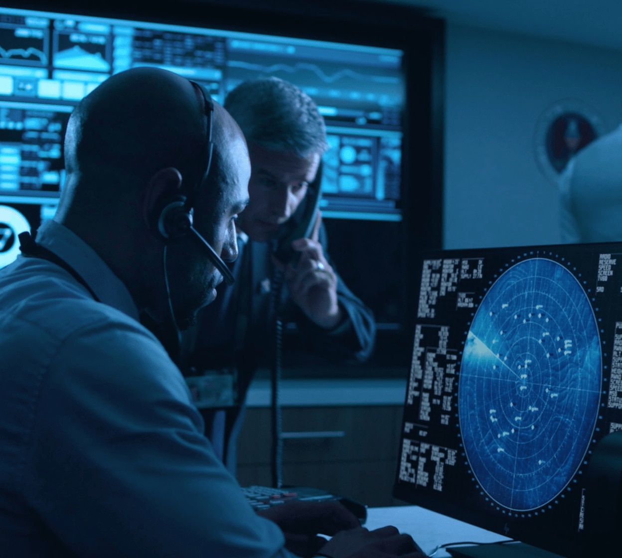 Men in military work on computer