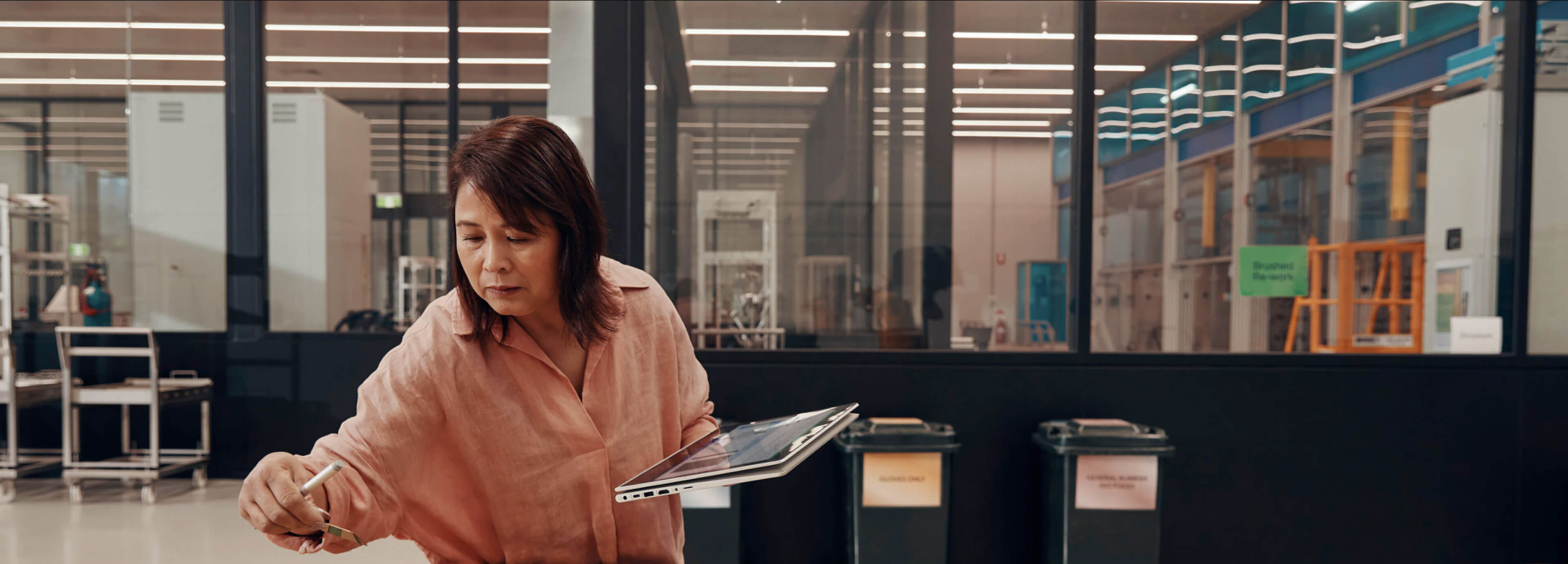 A woman working in an office with an HP ProBook in tablet mode