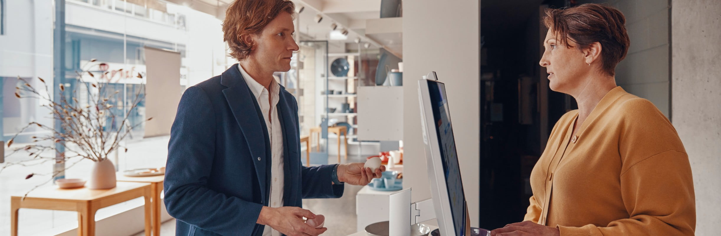 Man and a woman standing at a counter with laptop