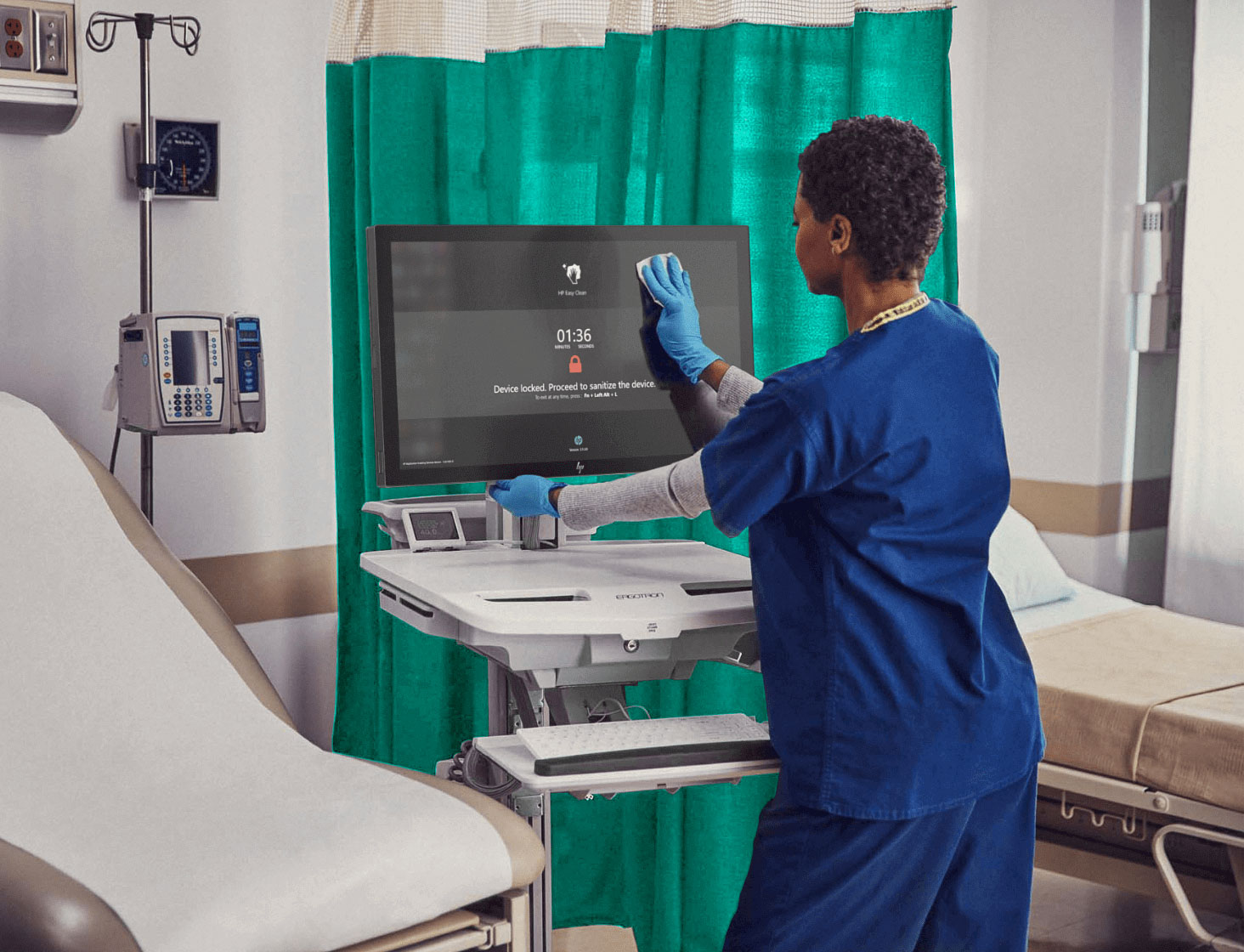 Woman disinfecting an HP Engage system in a hospital room