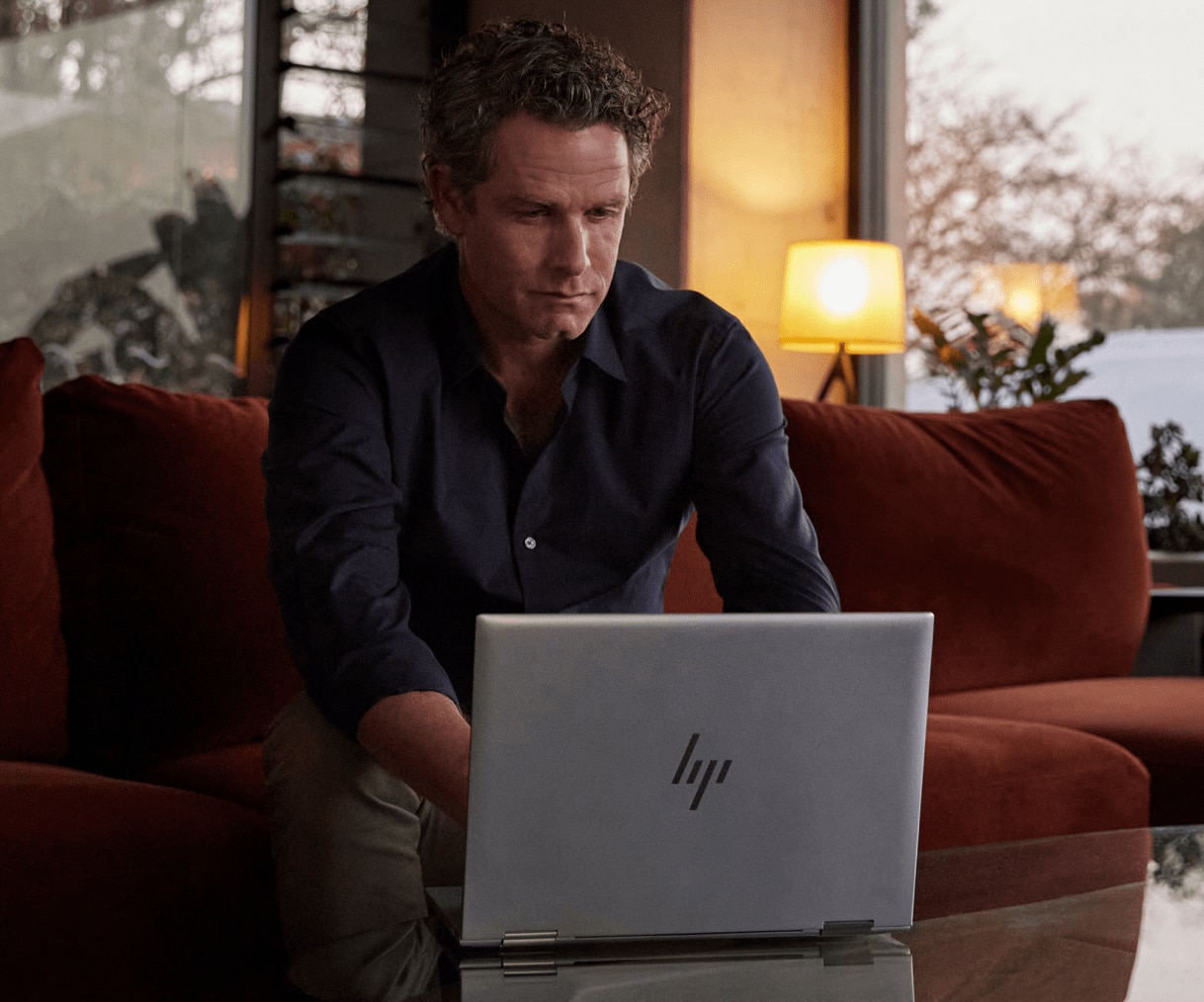 Man working on HP laptop from home in the evening