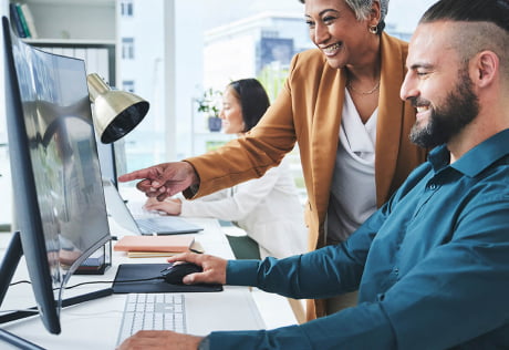 People reviewing information on monitor screen