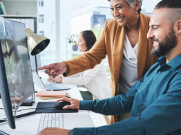 People reviewing information on monitor screen