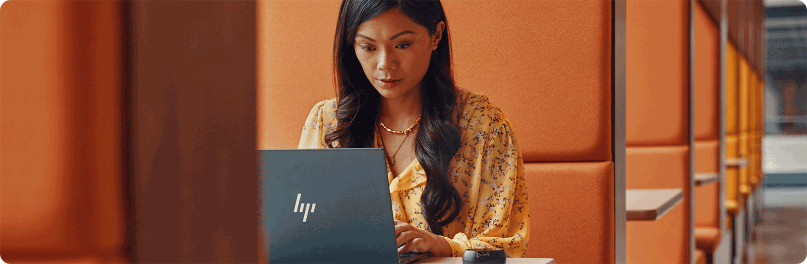 professional woman in modern work area using HP laptop
